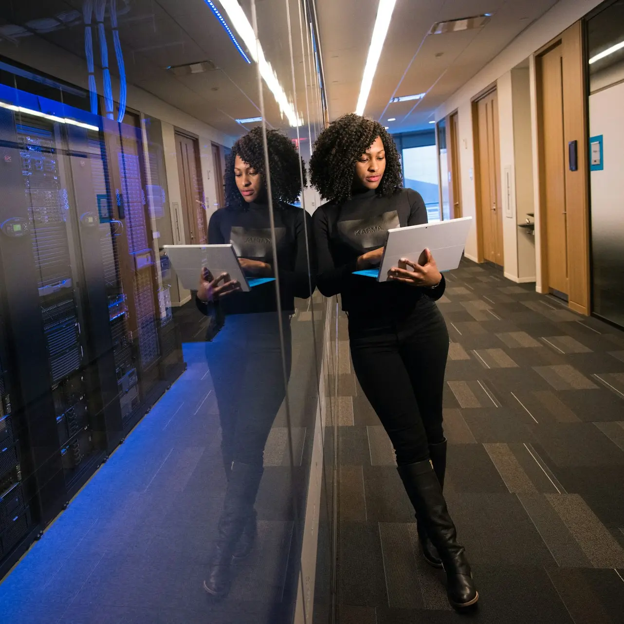 woman in black top using Surface laptop